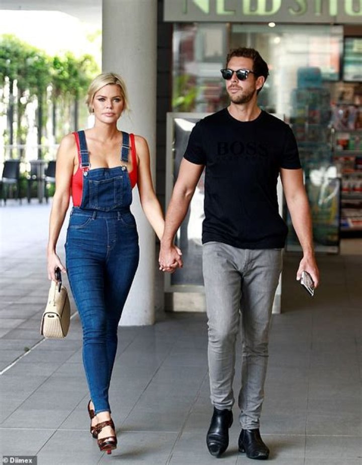 Sophie Monk and boyfriend Joshua Gross hold hands at Perth Airport