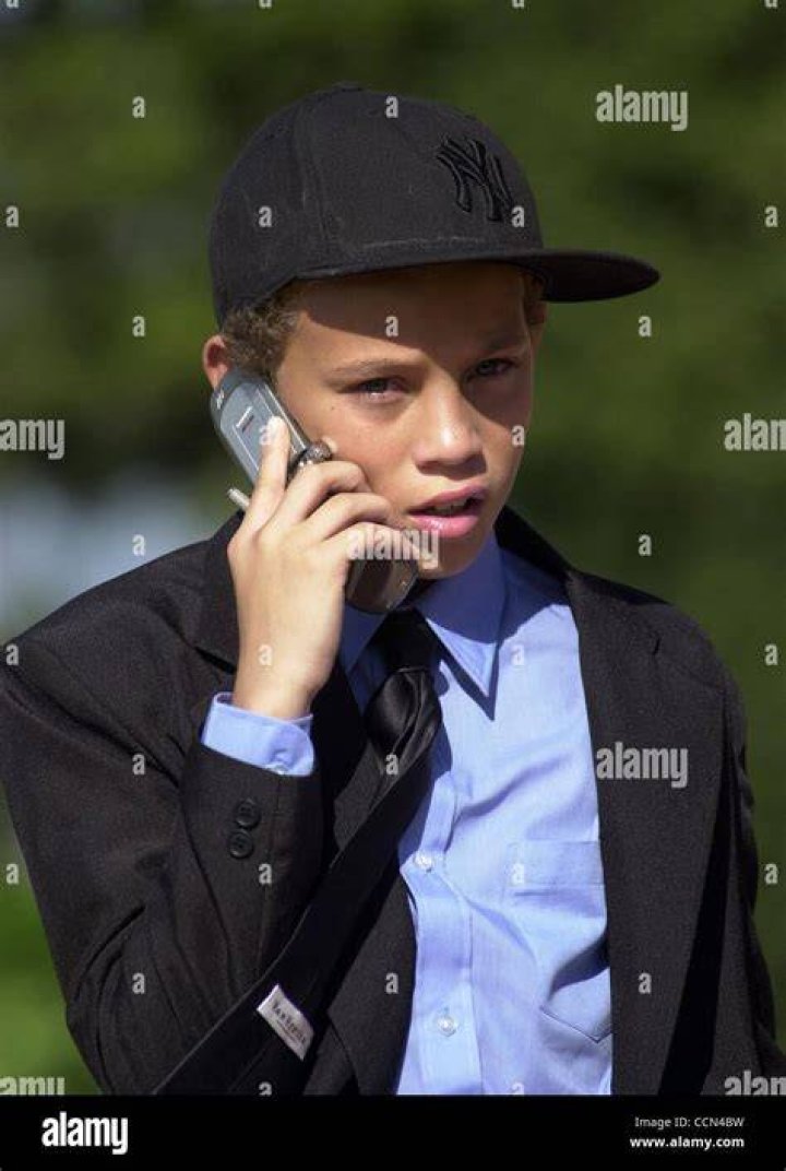 Tazman James, 12, the son of Rick James, waits outside the chapel at
